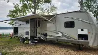 RV Trailer on Lakefront site with fishing boat