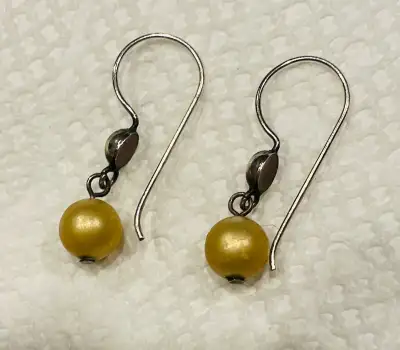 Classic gold coloured pearl dangle earrings, View more