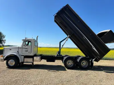378 Peterbilt. CBI grain/silage box. Tires are good. Tarp is good. 20’ box with hydraulic silage gat...