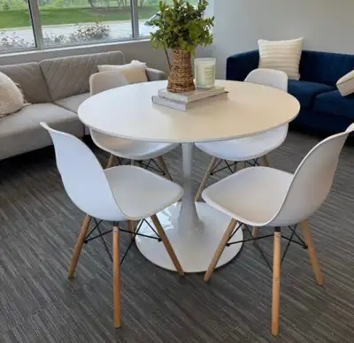 Sleek and stylish round white dining set ideal for smaller spaces. Tulip-inspired single pedestal ba...