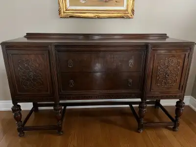 This is a beautiful nine-piece dining room set from the 1920s with a swing-leaf table. It is made of...