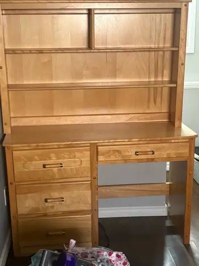 This is a wooden desk with hutch and multiple drawers. The desk is used but in good condition. It's...