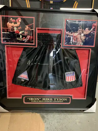 Brand new , professionally framed full size boxing trunks. Autographed by “iron” Mike Tyson. Direct...
