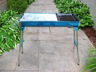 Selling this Brand New SILVER Stainless Steel Portable Camping Outdoor BBQ Grill on an built in Fold...