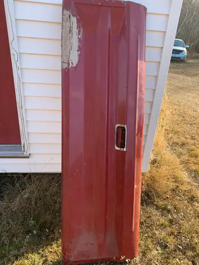 I'm selling a red tailgate from a 70s Ford half-tonne truck, perfect for restoration or repair proje...