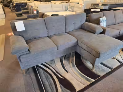 Sink into comfort with this stylish grey sectional sofa, perfect for lounging and entertaining in an...