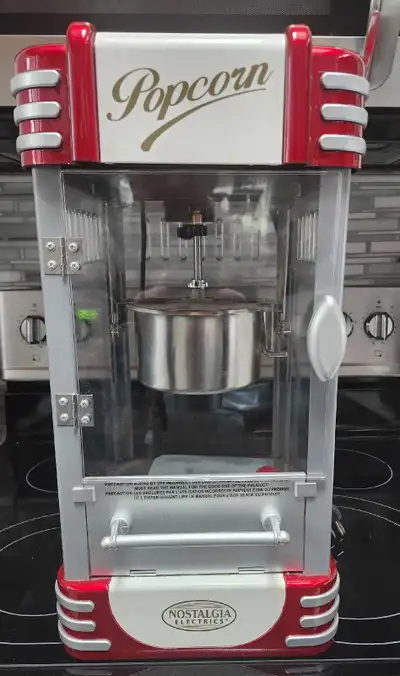 Get ready to enjoy movie-theatre popcorn in the comfort of your home with this Nostalgia Electrics r...