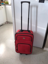 RED TRAVELLING SUITCASE ON WHEELS