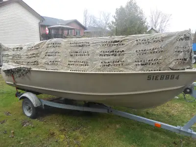 14 Foot lund boat deep/wide with trailer 25 johnson motor hunting blind gas can all in great shape $...
