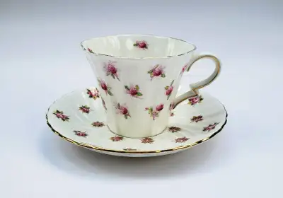 A mixed and matched tea cup set with Royal Albert Bone China Tea Cup and Aynsley Saucer in the Rose...