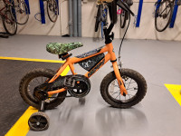 Kids bike real tree orange in good condition.