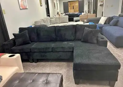 This brand new 4 seater L-shaped corduroy sofa features a deep black finish, integrated cup holders,...