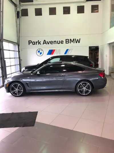 This stunning 2019 BMW 430i xDrive Coupe combines performance and luxury, featuring a sleek grey ext...