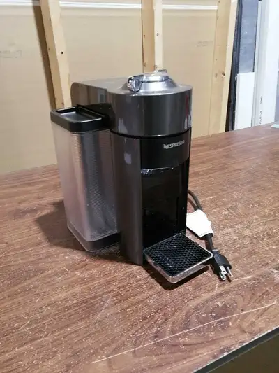 This is a Delonghi Nespresso coffee machine, perfect for brewing rich espresso at home. It is used,...