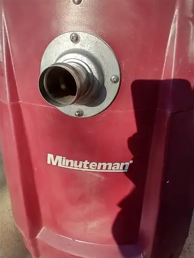 Survivor Backpack wet dry vacuum is the blue and Minuteman wet dry vacuum the dark red. . The dark r...