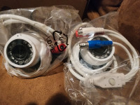 Pair of Swann PRO-1080FLD outdoor security cameras with wiring