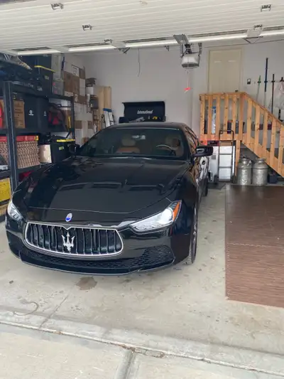 Selling my 2014 Maserati Ghibli, sleek black with dark windows from the factory and saddle brown lea...