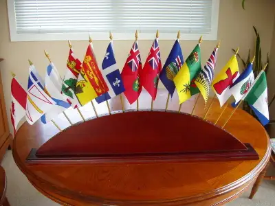 Flag stand will hold up to 52 flags. 31in. long by 7 in. high with 4 in. wide base. Flags are extra.