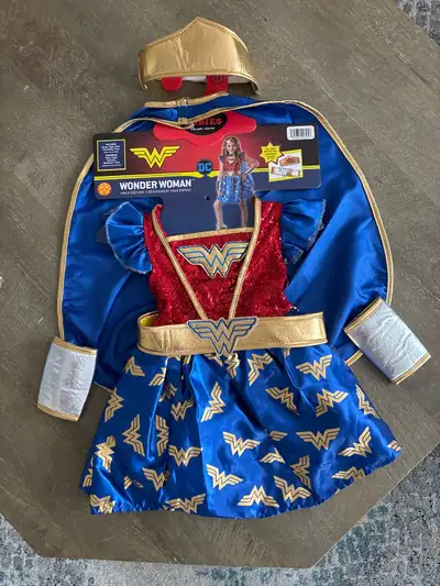 Selling a brand new girls Halloween costume Wonder Woman complete with all original accessories size...