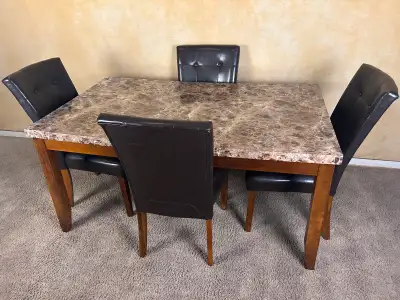 I have a used faux marble/wooden dining table and 4 chairs for sale for $250 or best offer. The dini...