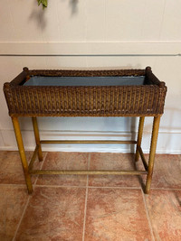 Vintage wicker plant stand .