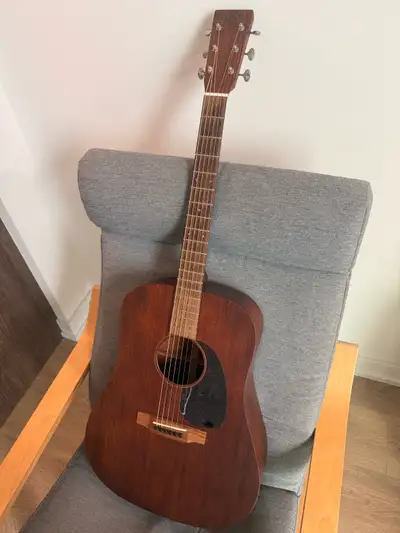 This is a used Martin D-15M acoustic guitar featuring a solid mahogany top, back, and sides, offerin...