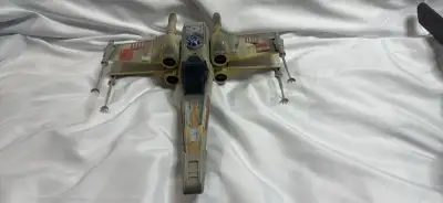 Relive the galactic adventures with this vintage X-Wing fighter! This toy shows signs of play, with...