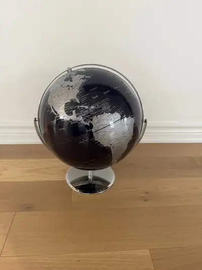 World Globe with Dark Blue Ocean and Chrome Metal Stand. Rotates round and up and down. High quality...