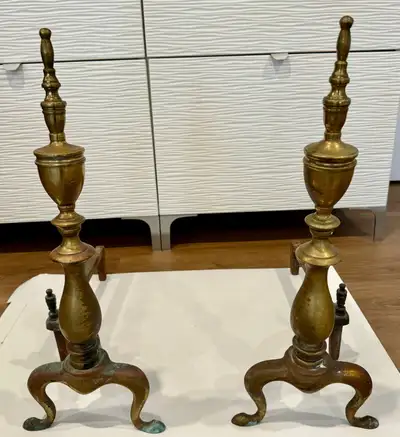 A pair of vintage solid brass fireplace andirons, with iron log holders, attached with bolt and nut....