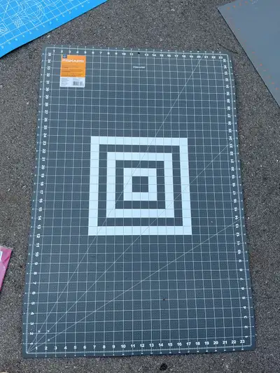 This is a Fiskars 24x36 inch two-sided cutting mat, perfect for crafting and sewing projects, with a...