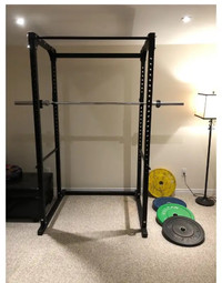 Squat rack with bar bell and bumper plates