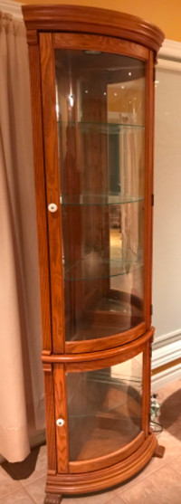 Corner display cabinet with overhead light, glass shelves, wood
