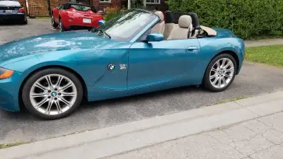 I am selling my 2006 BMW Z4 convertible, a stylish and fun-to-drive roadster with a striking blue ex...