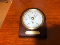 Barometer dial which can be used to measure air pressure.