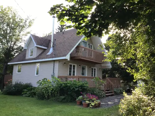 CHARMING FOUR SEASON HOME, Chalet style. The 2 bedrooms upstairs have an exterior door to their own...