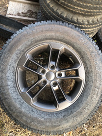 5 Jeep rims with 4 studded tires and factory spare. 