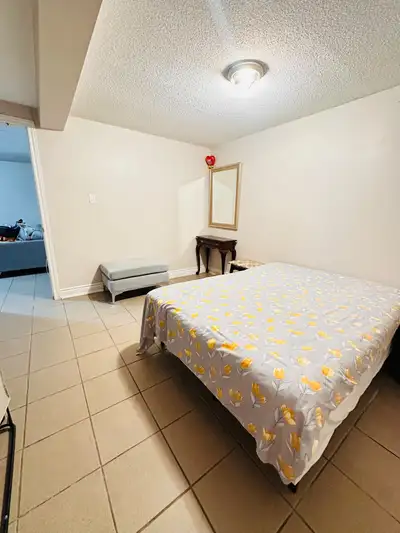 neat and clean private room for rent in Etobicoke. Um, spacious with a bed, dresser, mirror, and cup...