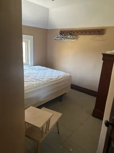 One furnished room for rent . Share kitchen and mane floor shower . Owe toilet and sink .
