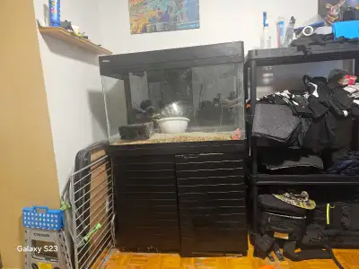 90 gallon Aquarium can be used for salt and fresh water. The stand has 2 cabinets.Some parts missing...