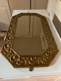 Vintage embossed copper framed bevelled wall mirror .