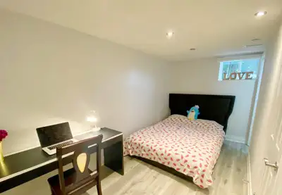 A semi-basement bedroom is available in a well-maintained home, featuring a private bathroom. The ba...