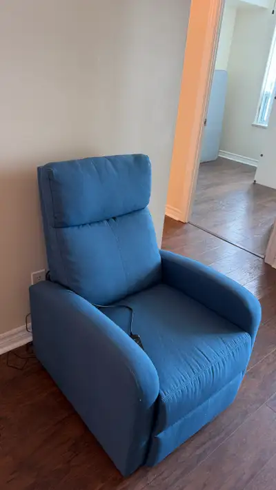 Comfortable blue recliner chair with built-in lower back massage function. The massage feature has b...