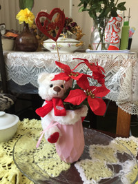 Teddy Bear Hugging a Vase with Beautiful Flowers