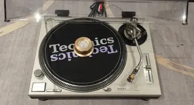 Technics SL-1200MK2 direct drive turntable and original dust cover. Includes a Stanton head shell wi...