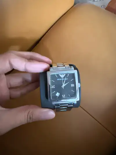 This is a used Emporio Armani watch with a square face and stainless steel band. This elegant timepi...