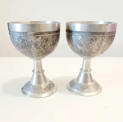 I'm offering a charm set of two Glaser Pewter goblets, each beautifully adorned with intricate flora...