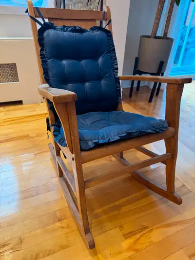 A beautiful, solid wood rocking chair with navy blue padded cushions (included). The frame is sturdy...