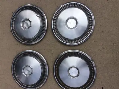FOUR CHEVY METAL HUBCAPS. 14 INCH DIAMETER. SOME DENTS AND SCRATCHES, PICK UP NEAR NORTHTOWN MALL. C...