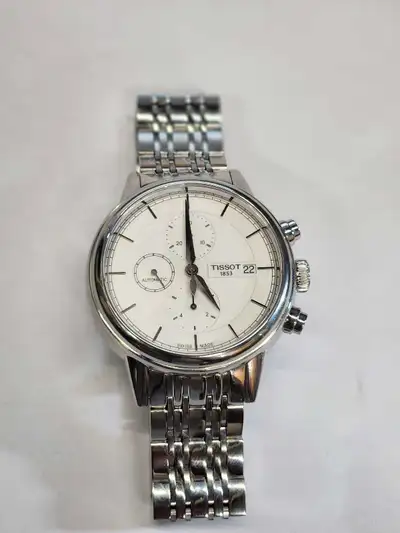 This is a Tissot watch, featuring an automatic movement and stainless steel bracelet, offering both...
