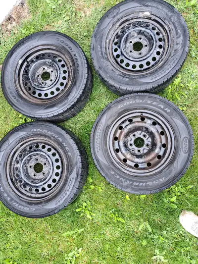 4 used Goodyear Assurance Triple tread tires. On rims for 2010 Chev Impala c/w covers. One has slow...